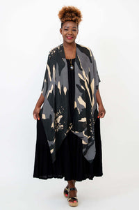 Front view of model wearing a black and beige patterned Darcy kimono wrap