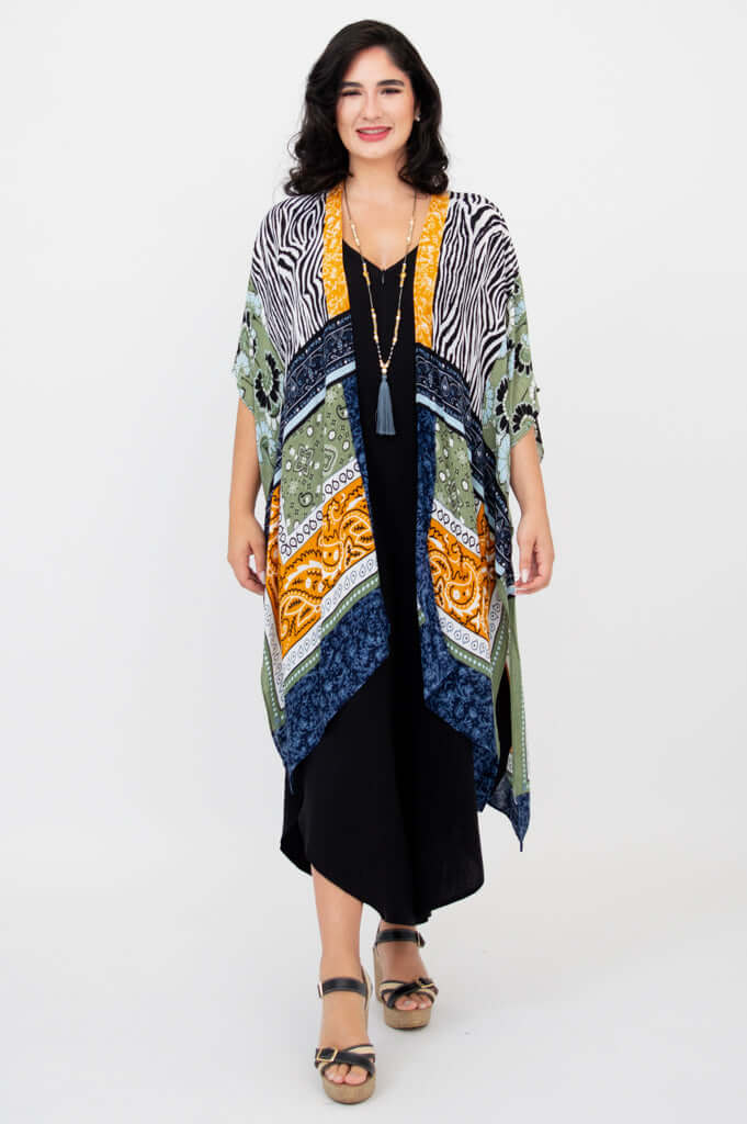 Front view of model wearing Darcy patterned kimono wrap over a black dress
