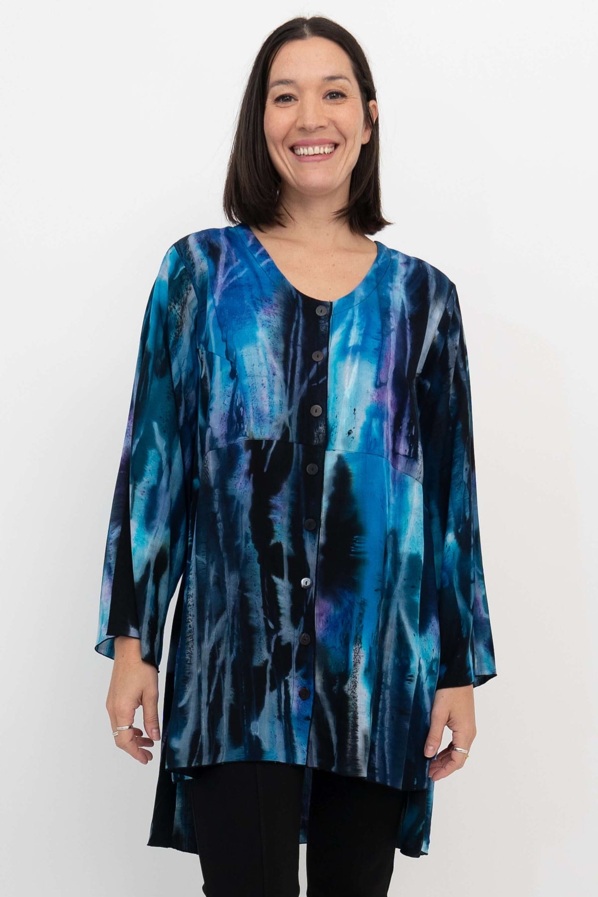 Front view of model wearing blue and black patterned Darla blouse with bell sleeves