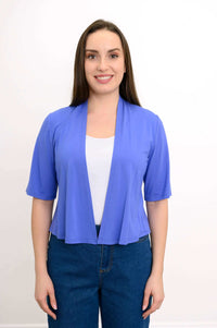 Front view of woman wearing a blue cropped short sleeve bamboo jacket over a white top