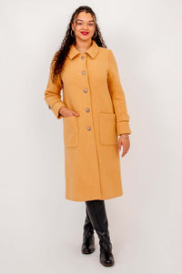 Front view of a model wearing the Edna wool blend coat in camel with patch pockets