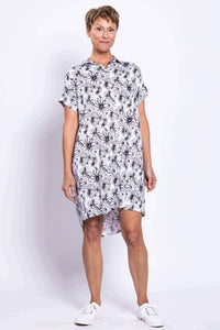 Front view of a woman wearing a black and white floral button-front shirt dress
