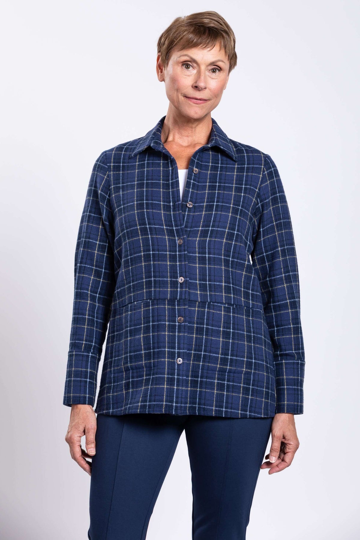 Front view of a woman wearing a blue plaid cotton jacket with button closure