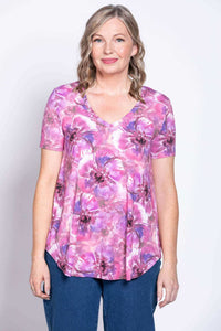 Front view of woman wearing a pink and purple floral V-neck bamboo top