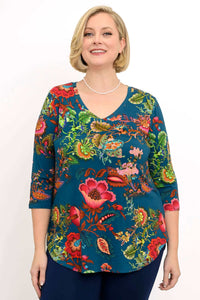 Woman wearing bamboo top with vibrant teal floral print, front view