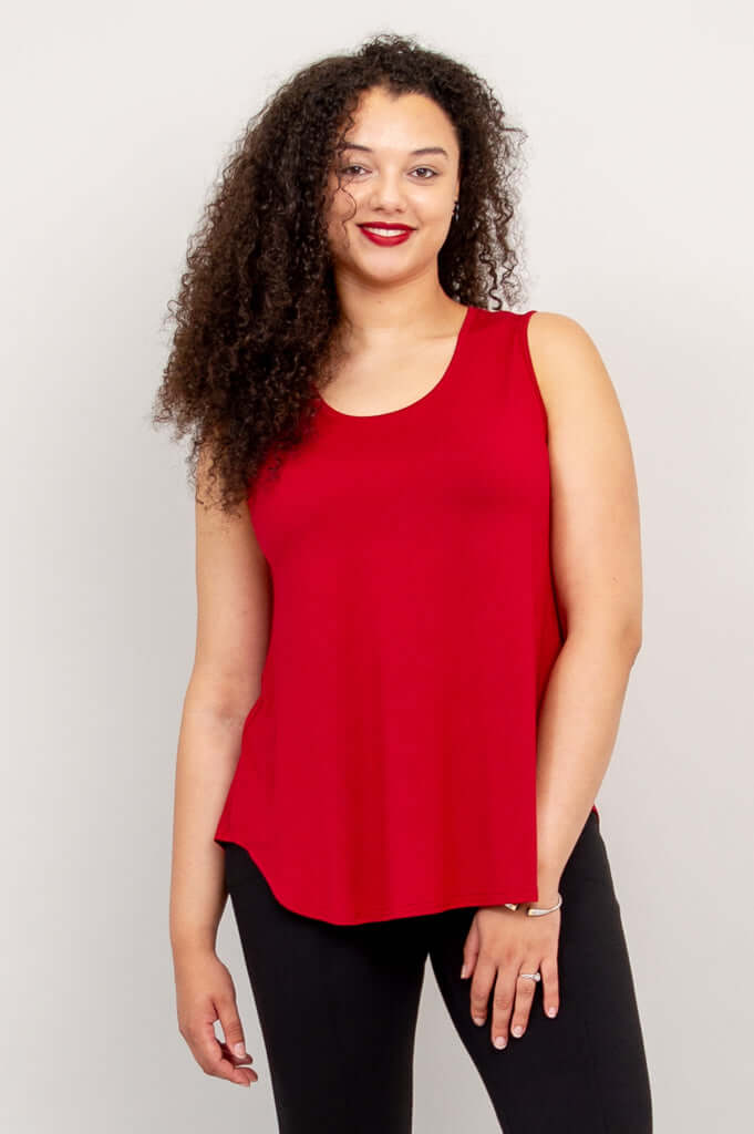 Front view of model wearing a cherry red Jazz Bamboo Tank Top with black pants