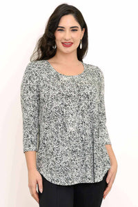 Front view of woman wearing black and white rose print bamboo top with 3/4 sleeves