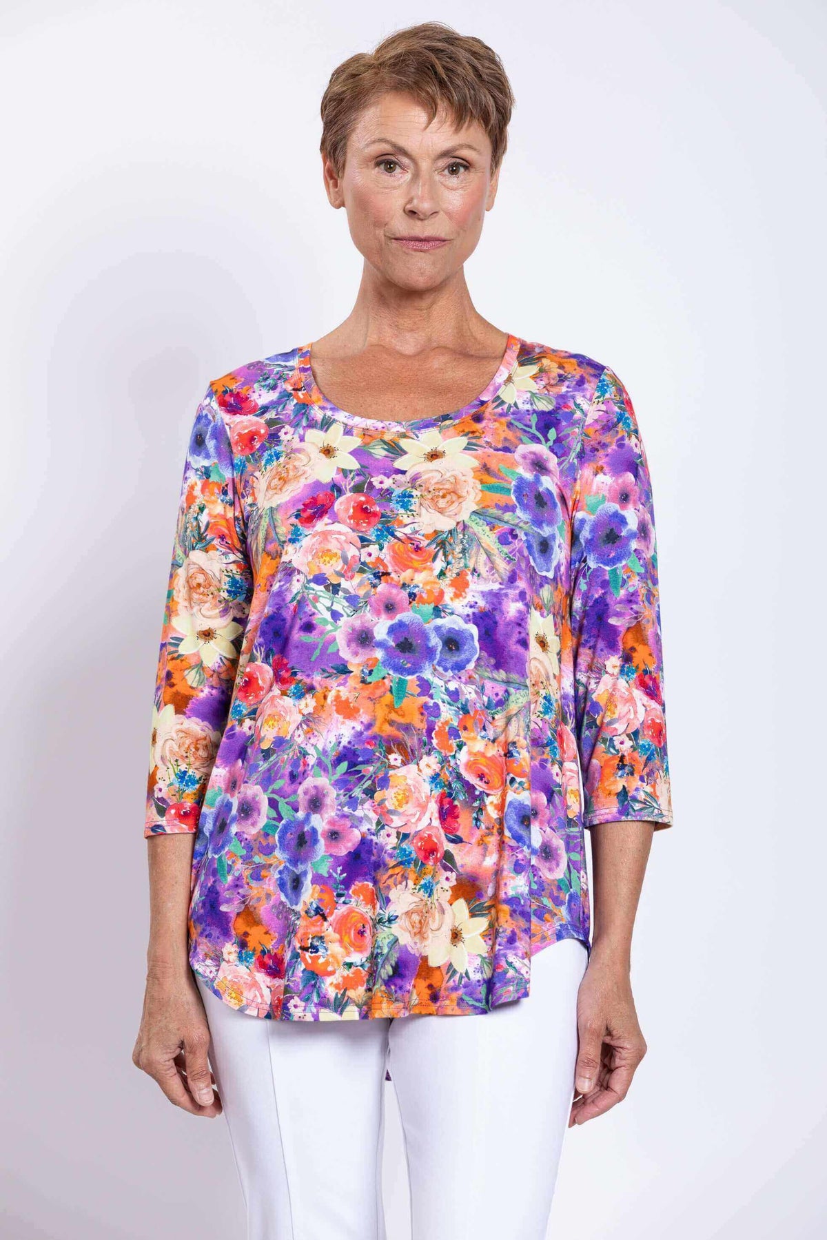 Front view of model wearing a colorful floral Jazz bamboo top with 3/4 sleeves