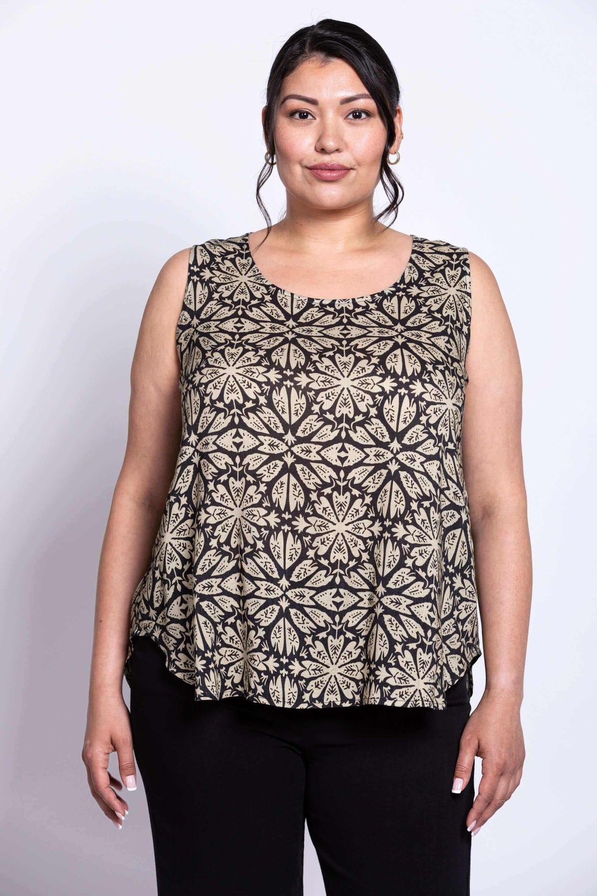 Front view of model wearing black and beige floral print top and black pants
