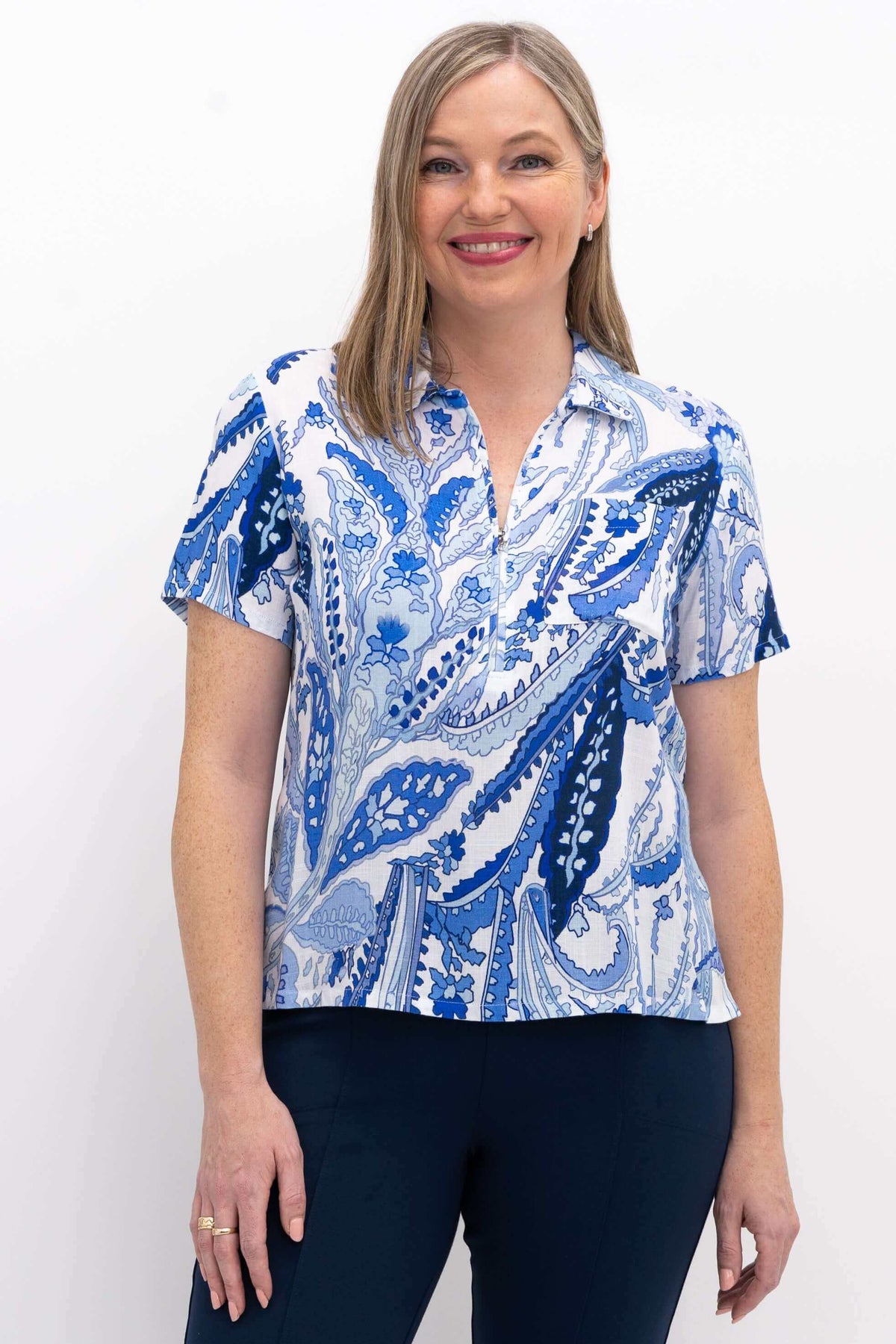 Front view of a woman wearing a Lala top with blue paisley print and short sleeves