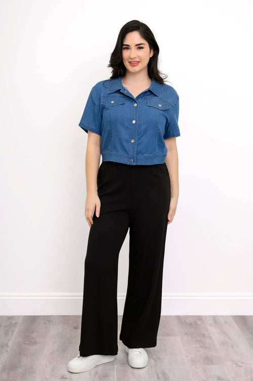 Front view of woman wearing Lana cropped Tencel denim jacket with black pants