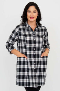 Front view of model wearing a black and white plaid flannel button-up tunic with 3/4 sleeves