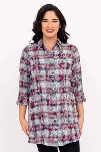 Front view of a woman wearing a plaid flannel tunic shirt with 3/4 sleeves