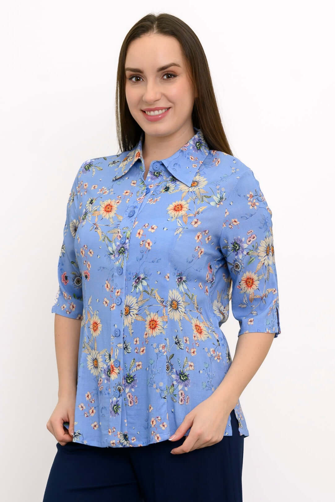 Front view of a woman wearing a blue floral bamboo-linen blouse with elbow-length sleeves