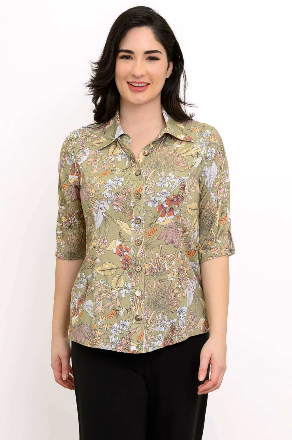 Front view of model wearing a green floral bamboo linen blouse with shirt collar and elbow sleeves