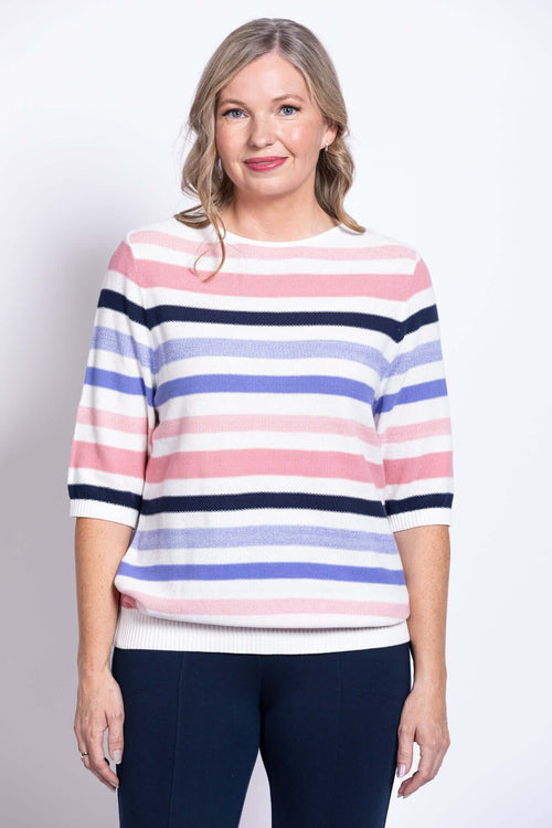 Front view of a woman wearing a pink, navy, lilac, and white striped cotton sweater