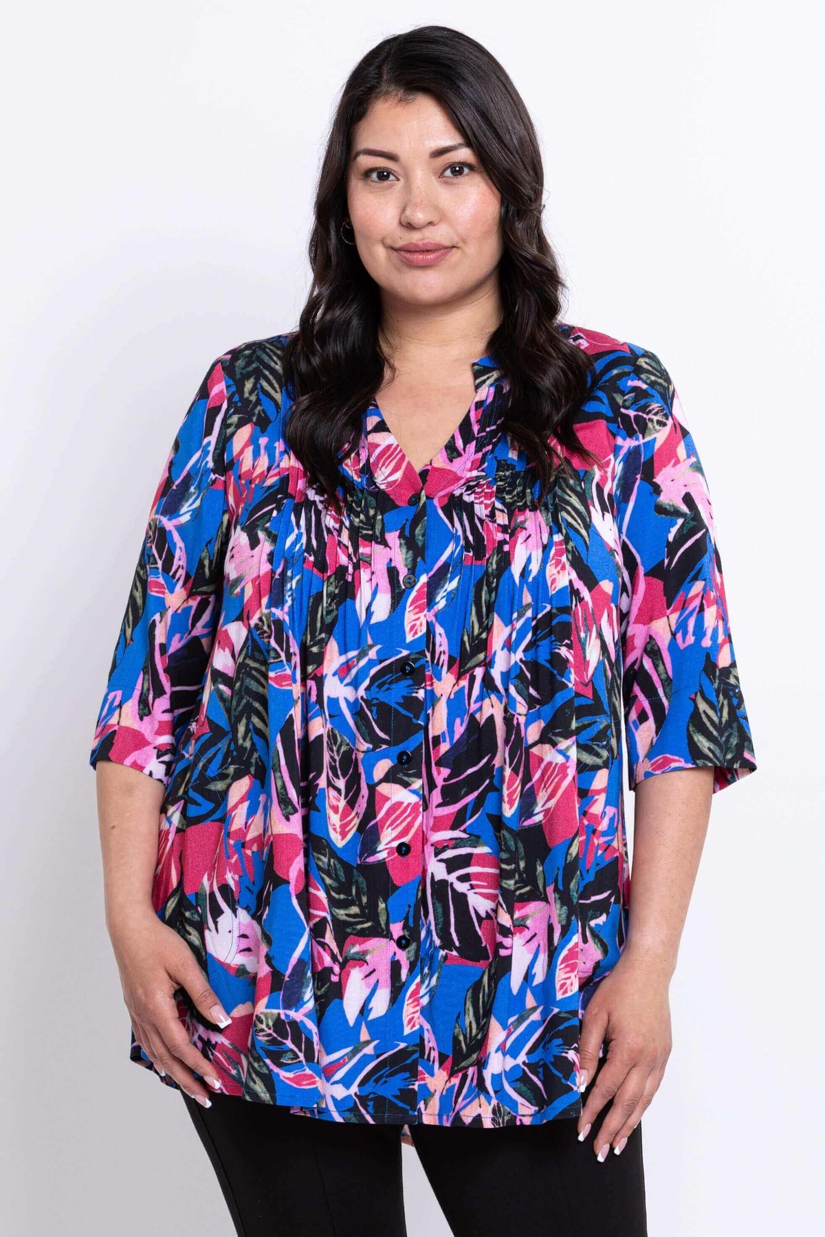 Front view of woman wearing a Margate blouse with colorful leaf print and pintuck details