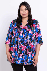 Front view of woman wearing a Margate blouse with colorful leaf print and pintuck details