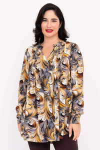 Front view of woman wearing Margate swirl blouse with gold, grey, and white print