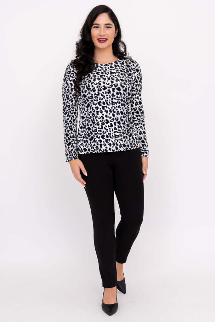 Woman wearing a long sleeve leopard print tee with black pants, standing front-facing