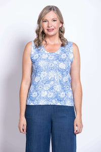 Front view of a woman wearing a blue floral tank top with wide straps