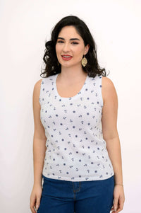 Woman smiling in a white nautical print tank top, front view