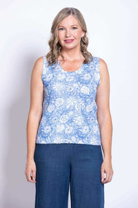 Front view of woman wearing blue floral tank top and wide-leg pants
