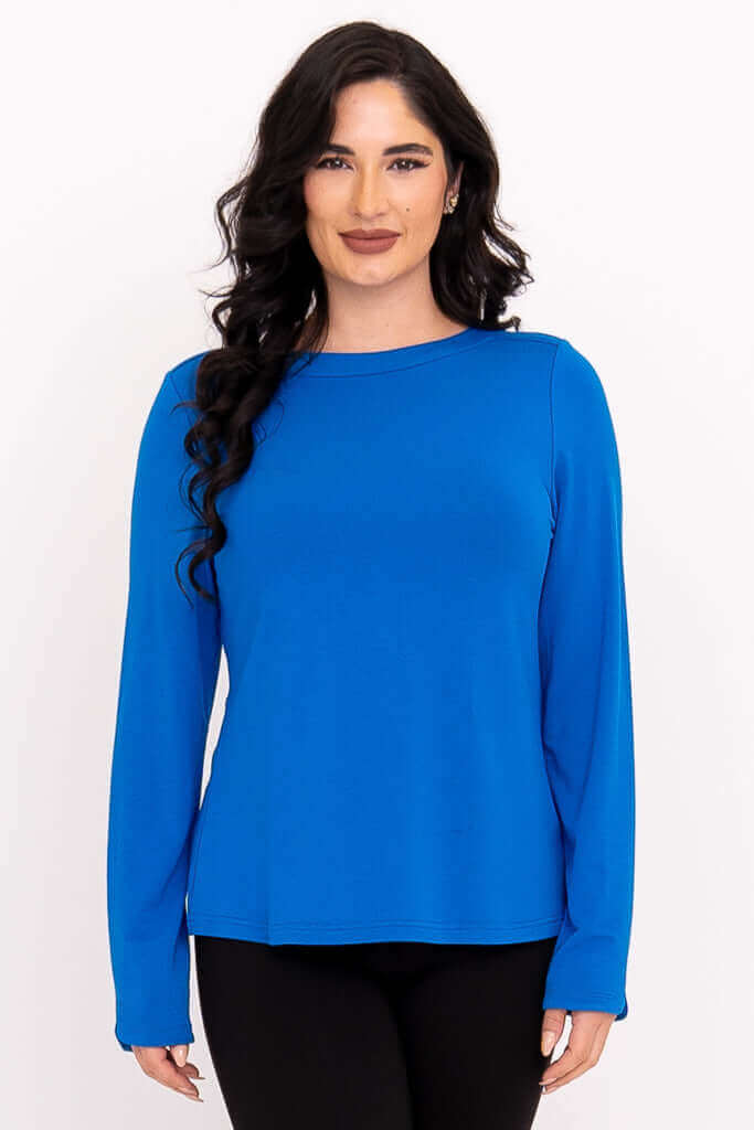 Front view of woman wearing a royal blue long sleeve boat neck top