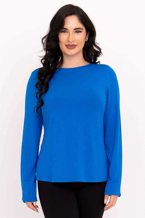 Front view of woman wearing a royal blue long sleeve boat neck top