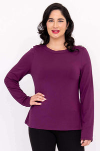 Front view of a woman wearing a long sleeve purple boat neck top