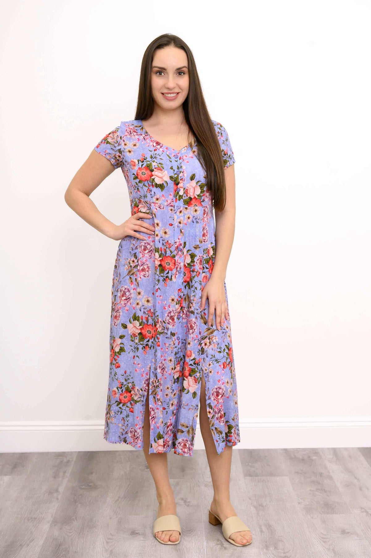 Front view of woman in Morgan floral midi dress with short sleeves and front slits