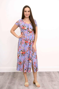 Front view of woman in Morgan floral midi dress with short sleeves and front slits