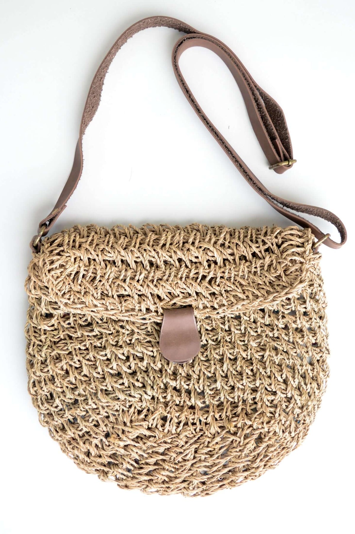 Front view of hand woven rattan purse with leather strap and clasp