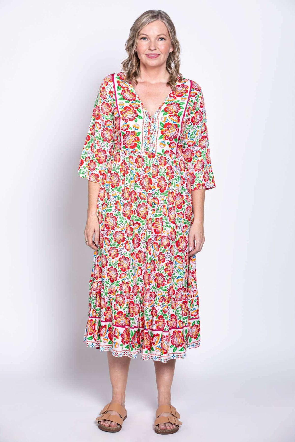 Model facing forward in ankle-length batik dress with colorful floral print