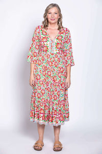 Model facing forward in ankle-length batik dress with colorful floral print