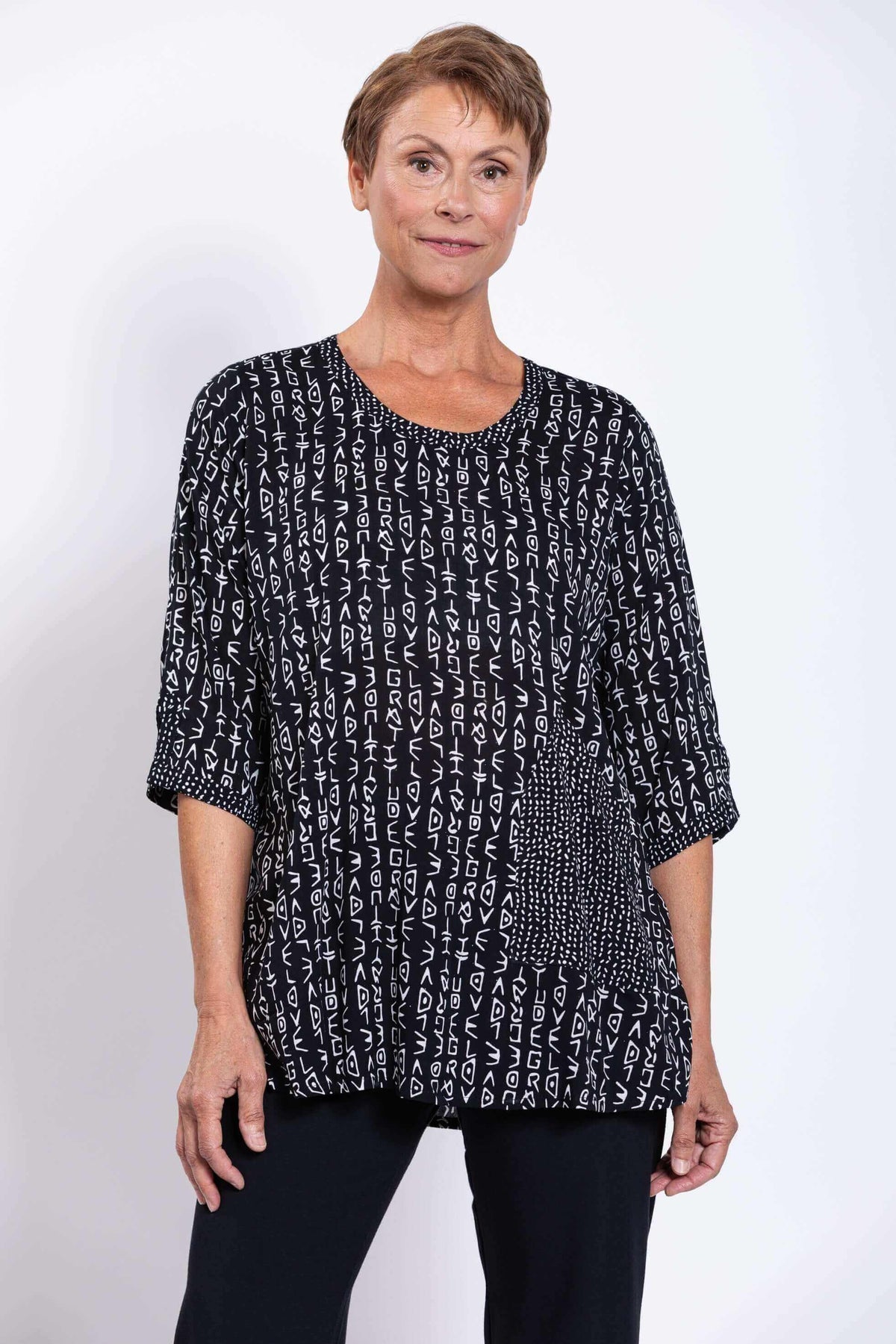 Front view of woman wearing Palace Blouse in black abstract print, scoop neckline