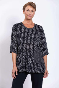 Front view of woman wearing Palace Blouse in black abstract print, scoop neckline
