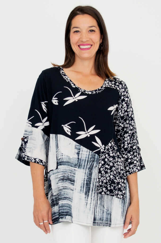 Woman wearing black and white Palace Blouse with abstract and floral patterns, front view