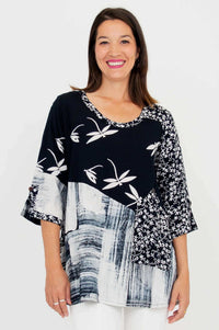 Woman wearing black and white Palace Blouse with abstract and floral patterns, front view