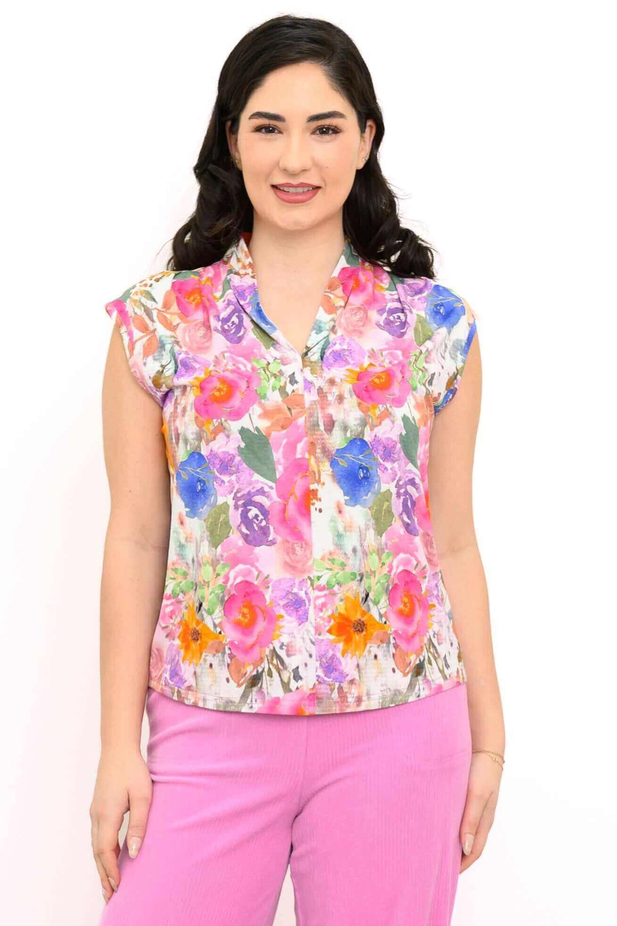 Front view of a woman wearing a vibrant floral shawl collar top with cap sleeves