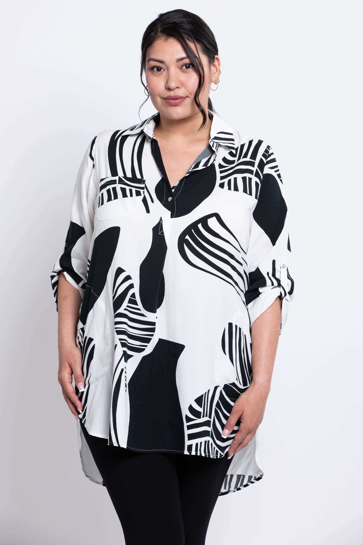 Front view of model wearing Queenie Tunic in black and white abstract print
