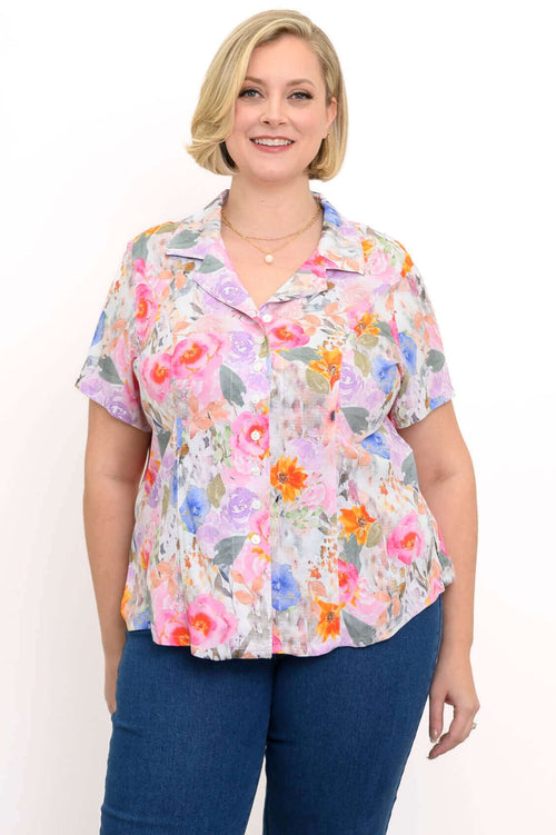 Front view of a woman wearing linen bamboo floral shirt with jeans