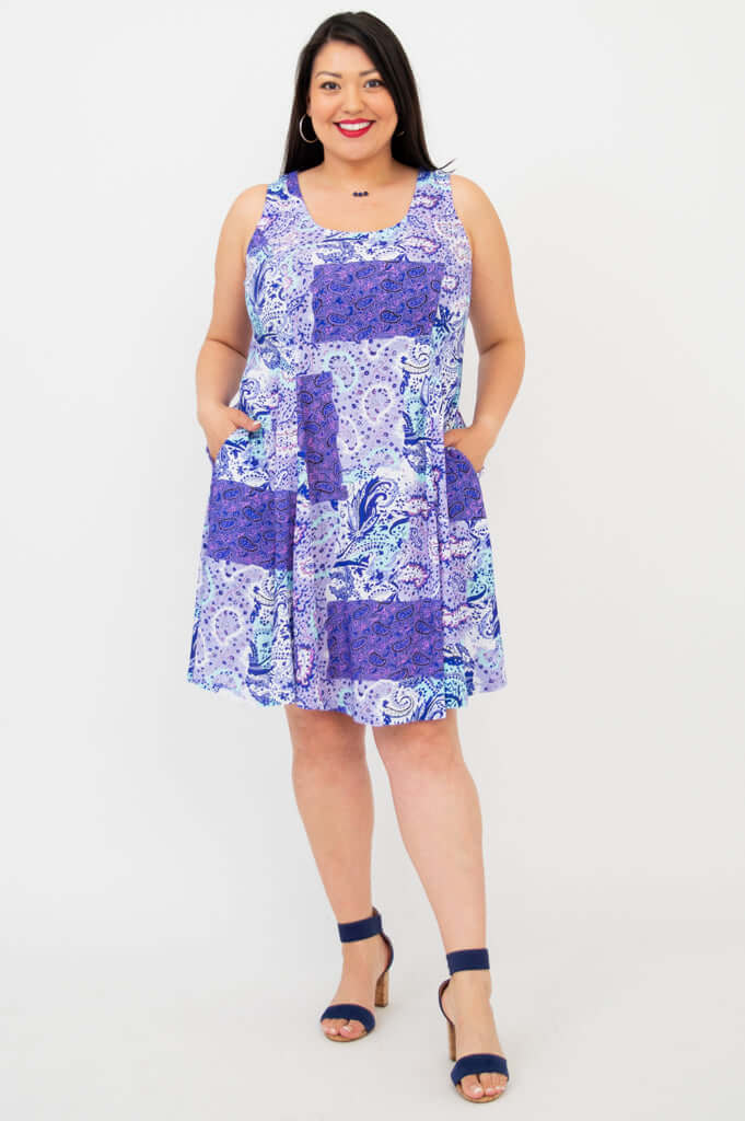 Front view of a woman wearing a sleeveless purple patchwork print A-line summer dress