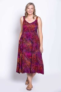 Front view of woman wearing a sleeveless purple and orange leaf print A-line dress