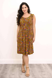 Woman wearing a brown sleeveless floral midi dress with pleated front