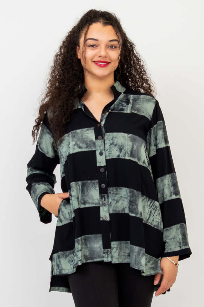 Front view of model wearing Talina Batik Stripe Blouse with hands in pockets