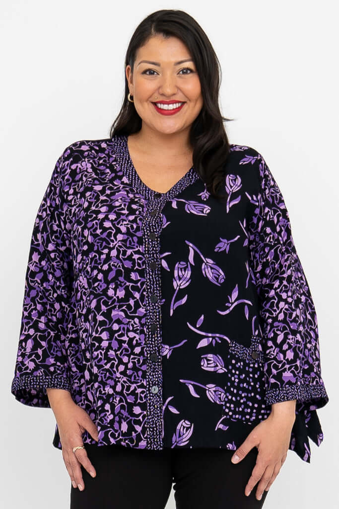 Front view of model wearing black and purple print V-neck button top