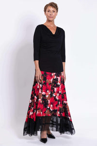 Front view of woman wearing a black top and red floral Vera Maxi Skirt with mesh hem