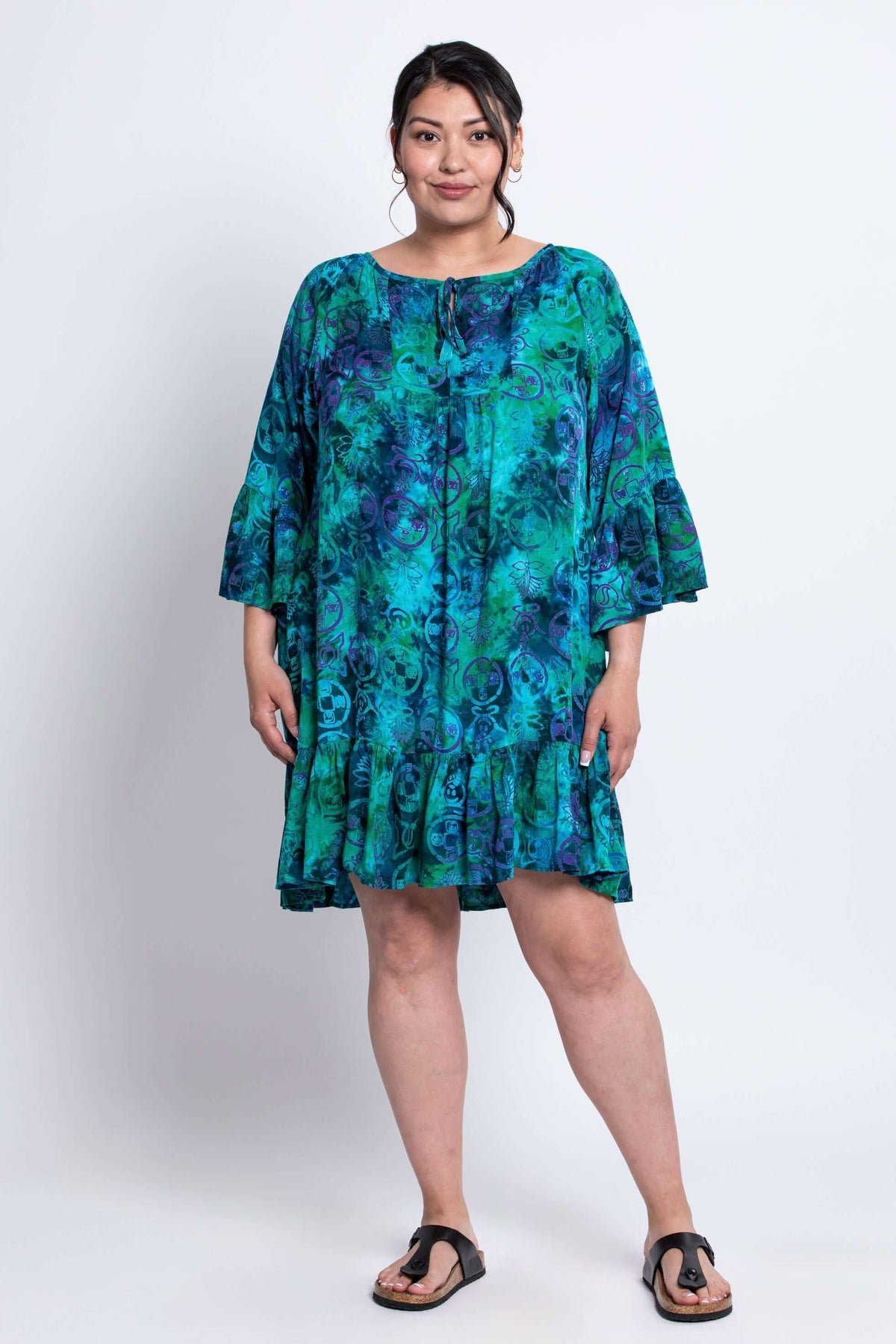 Front view of model wearing Wanda blue green boho style dress with ruffled hem and sleeves