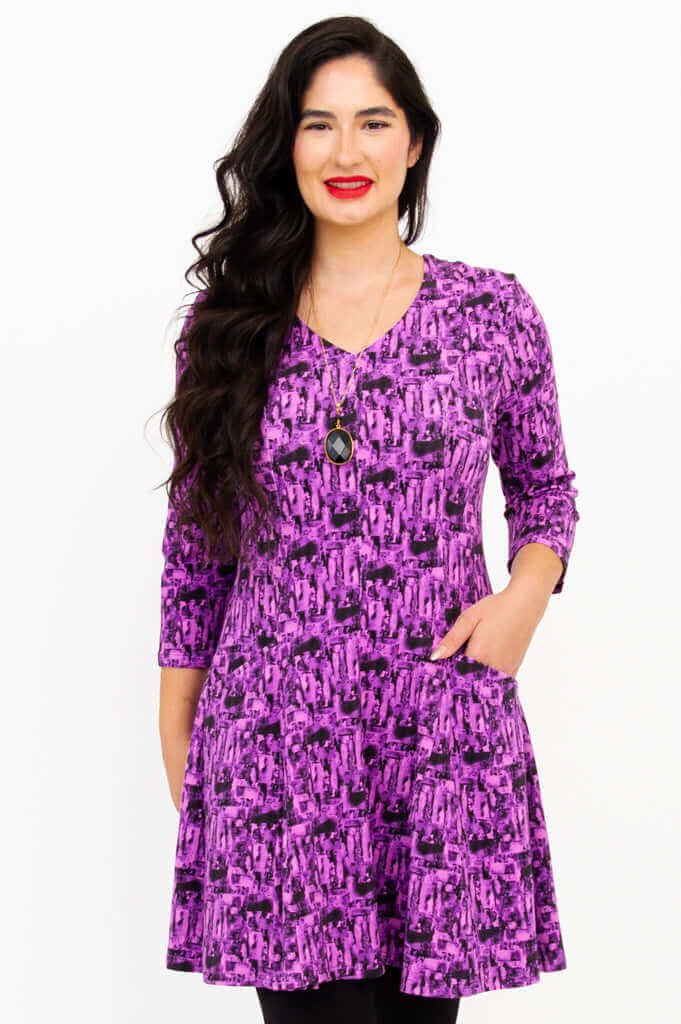 Front view of model wearing Wilma Tunic in Violet Brush print with pockets